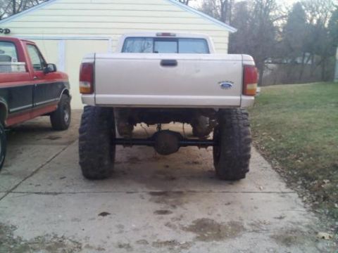 1997 Ford Ranger - Rear view of a lifted 1997 Ford Ranger pickup truck with oversized tires.