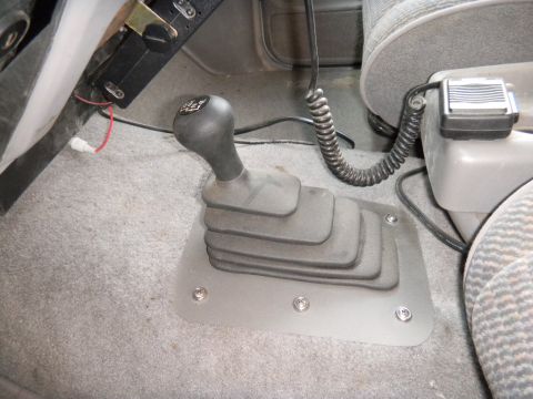 1997 Ford Ranger - Interior shot of a vehicle's manual transmission shifter and a CB radio mounted on the center console.
