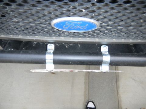 1997 Ford Ranger - Close-up of a Ford emblem and bumper assembly, with a license plate attached.