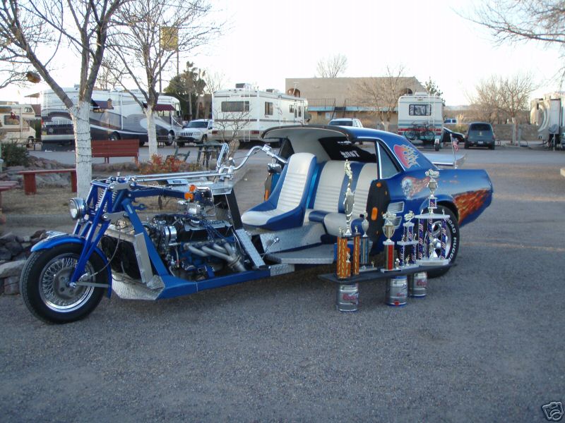 Blue custom trike with car body, trophies displayed