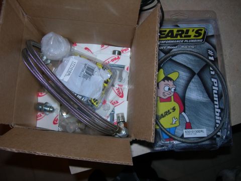 1991 Jeep Wrangler - Earl's Performance Plumbing parts, including braided hoses and fittings, are shown in a cardboard box.