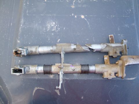 1992 Ford F-350 - Two metal shifter linkage rods are shown, with one rod appearing to be broken.