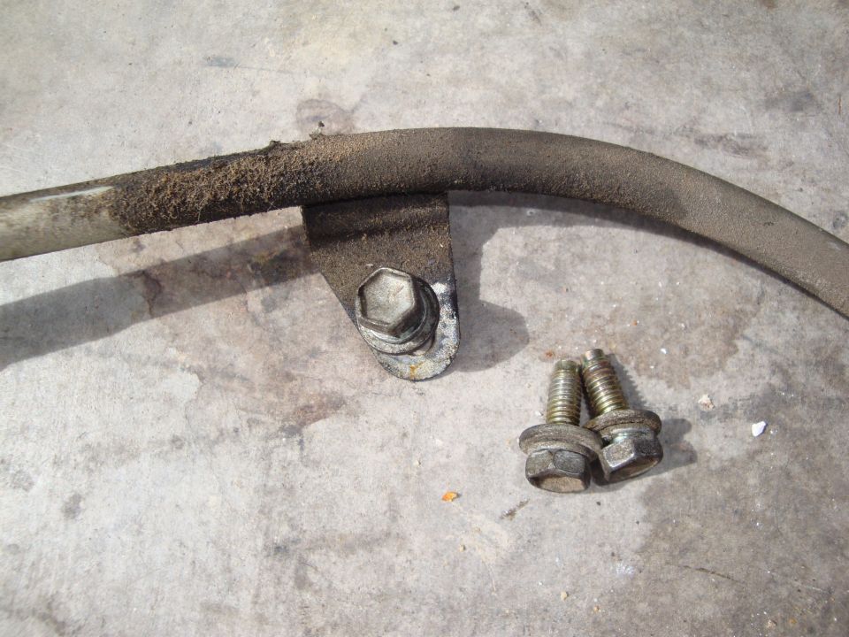 Sway bar with mounting bracket and two bolts on concrete