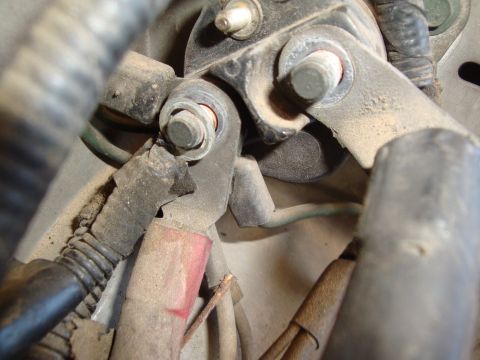 1990 Ford Taurus - Detail of a vehicle's electrical wiring harness connection, showing a bolted terminal.