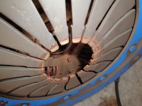 1990 Ford Taurus - Close-up of a clutch pressure plate, showing wear on the friction surfaces.