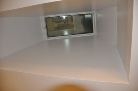 1996 Ford Bronco - The interior of a white room is shown, a small, grimy window.