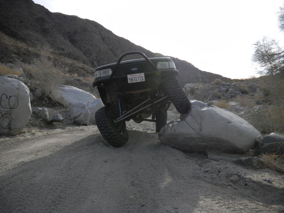 1997 Ford Ranger climbing rocks, front bumper visible