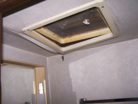 1974 Dodge RV/Conversion Chassis - Close-up of an interior ceiling vent, showing yellowed foam insulation and a dirty vent cover.