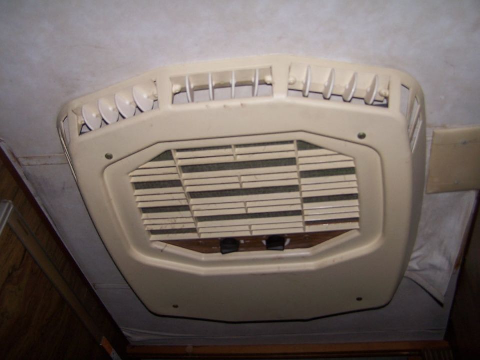 Cream-colored RV roof air conditioner interior vent and filter unit
