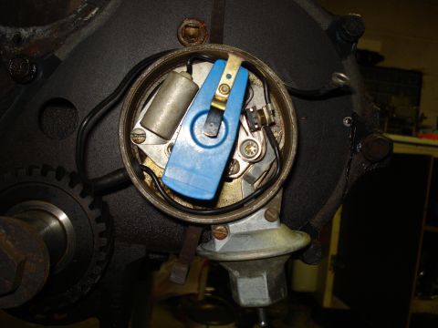 1991 Ford Bronco - Close-up view of an engine's ignition distributor cap and rotor assembly.