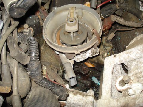 1991 Ford Bronco - Close-up view of a vehicle's distributor cap and rotor, showing internal components and wiring.