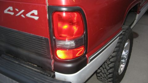 1997 Dodge 2500 - The rear of a red 1997 Dodge 2500 pickup truck is visible, showing the taillight and a 4x4 decal.