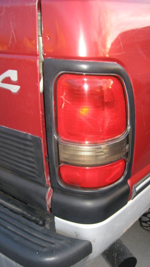 1997 Dodge 2500 - Close-up of the rear taillight assembly on a red 1997 Dodge 2500 pickup truck.