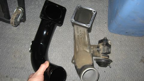 1997 Dodge 2500 - Two intake manifold parts are shown, one new and black, the other old and dirty.