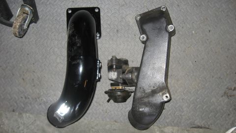 1997 Dodge 2500 - Intake manifold and turbo actuator parts shown on a textured surface.