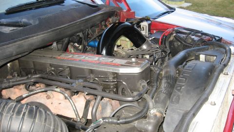 1997 Dodge 2500 - The engine bay of a 1997 Dodge 2500, the prominent red 'DODGE' lettering on the valve cover.