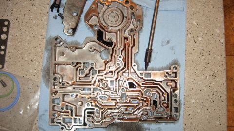 1997 Dodge 2500 - Transmission valve body disassembled, showing complex internal passages and components.