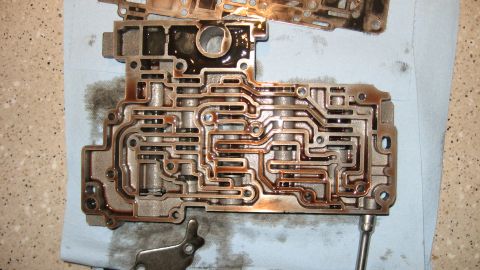 1997 Dodge 2500 - This is a close-up view of a disassembled automatic transmission valve body, showing its complex internal hydraulic passages.