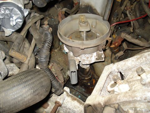 1991 Ford Bronco - Close-up view of an engine's distributor cap and associated wiring, showing signs of wear and repair.