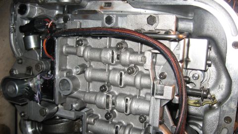1997 Dodge 2500 - This is a close-up view of an automatic transmission valve body, showing intricate mechanical components and electrical connectors.