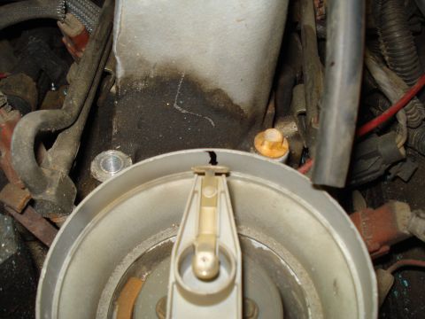 1991 Ford Bronco - Close-up of a cracked distributor cap and rotor, part of a vehicle's ignition system.