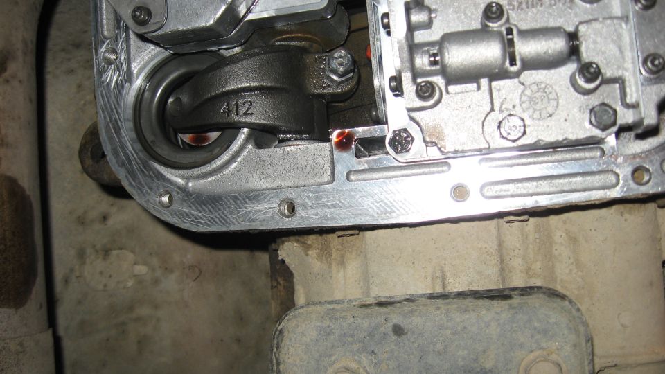 Transmission pan with internal linkage marked 412 and SuperMotors.net logo