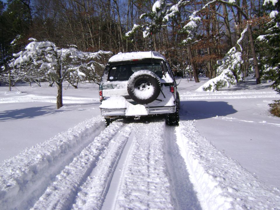 1994 Ford Bronco rear view in snow with spare tire mounted