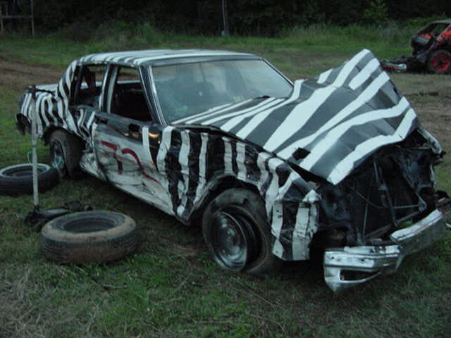 That's how she looked after the heat tonight.  Two flats, hood up so high I couldn't see driving back to the pits.  HEHE what a blast!  We had 15 minutes after the winners from the last heat were pulled into the pits to work on the cars.  I got both right tires changed and the hood back down, and beat out the right front fender.