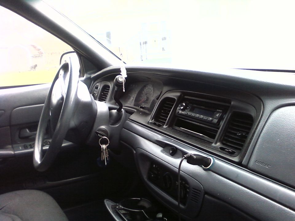 Black sedan interior with steering wheel, keys in ignition, Sony stereo, and dashboard