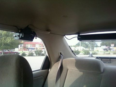2000 Mercury Grand Marquis - Aftermarket electronics installed in the rear of a vehicle, view from back seat.