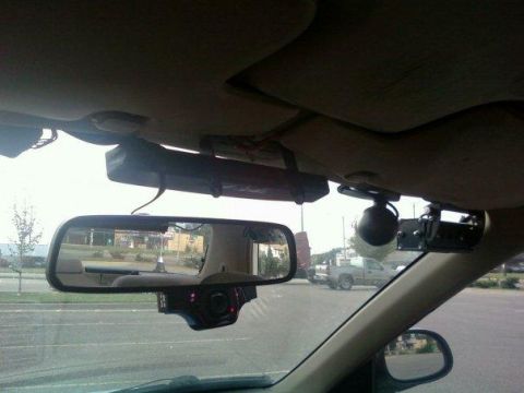 2000 Mercury Grand Marquis - The interior of a 2000 Mercury Grand Marquis is visible, equipped with a dashcam and a first aid kit.