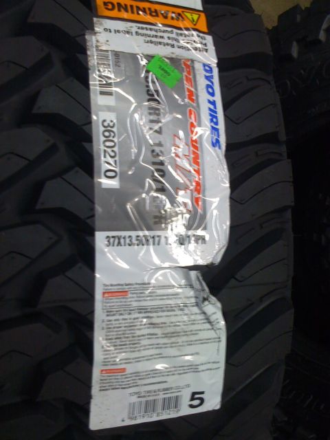 1996 Ford C-350 (Centurion Conversions) - A close-up view of a Toyo Open Country M/T tire, its size designation and warning labels.