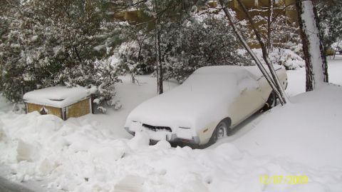 1972 Ford Ranchero - A 1972 Ford Ranchero is buried in snow, with only its front end partially visible.