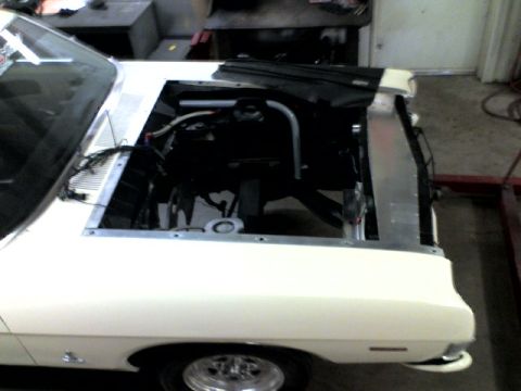 1963 Ford Fairlane - A white 1963 Ford Fairlane is shown with its hood open, revealing the engine bay and radiator.
