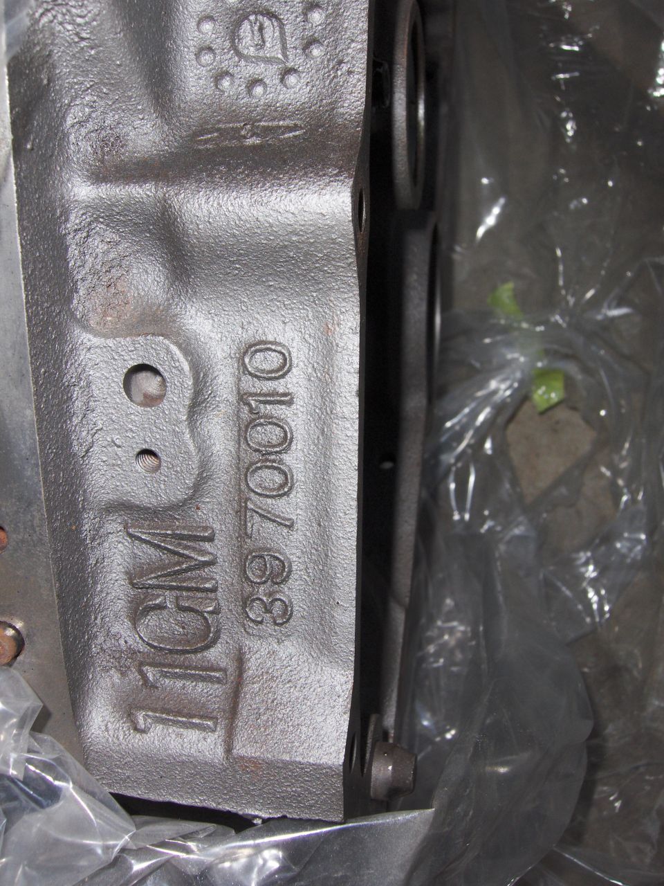 Close-up of a cast iron engine block with "11GM" and casting number "3970010" visible