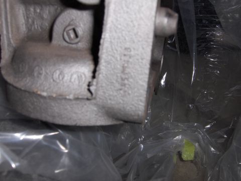 1970 Chevrolet Camaro - Close-up of a cast metal component showing stamped numbers and a crack.