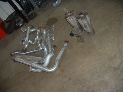 1963 Ford Fairlane - Pair of exhaust headers and two sets of mufflers are visible on the floor.