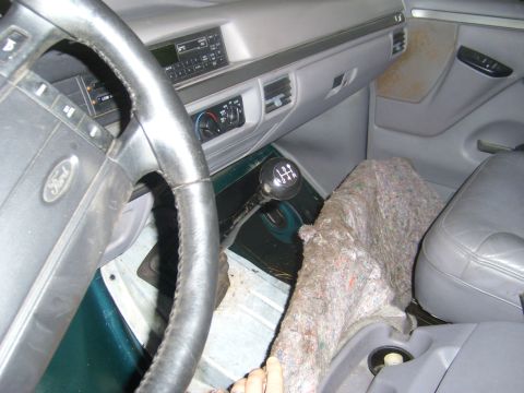 1994 Ford Bronco - The interior of a 1992 Ford Bronco features a manual transmission and a gray dashboard.