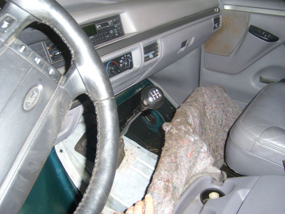 Interior of a 1992 Ford Bronco with a manual transmission, showing the steering wheel, dashboard, and gear shifter