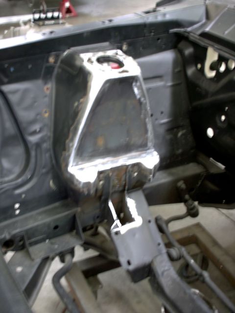 1963 Ford Fairlane - Close-up view of a car's engine bay, showing structural modifications and suspension parts.