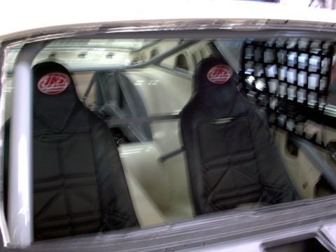 1963 Ford Fairlane - Custom racing seats and roll cage installed in a vehicle's interior.