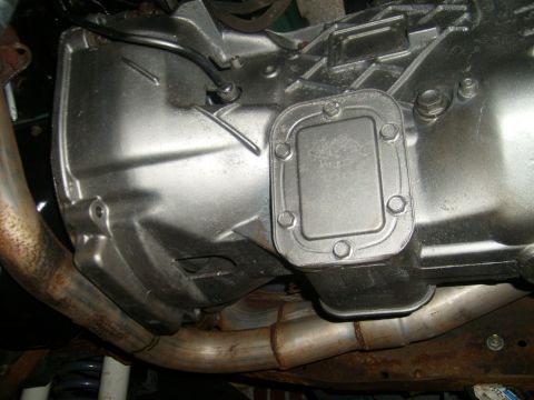 1994 Ford Bronco - Underside view of a vehicle's transmission and exhaust system components.