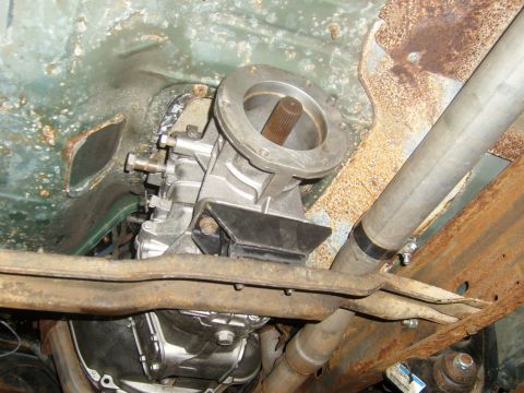 1994 Ford Bronco - The underside of a vehicle reveals its transmission and exhaust components, with visible signs of rust.