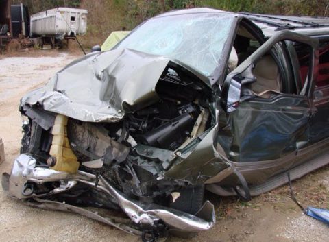 1995 Ford Bronco - This heavily damaged SUV shows extensive front-end collision damage.