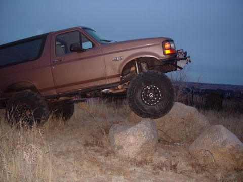 1993 Ford Bronco - Modified 1993 Ford Bronco navigating rocky terrain during an off-road excursion.