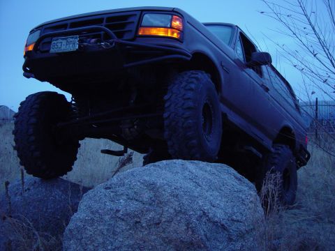 1993 Ford Bronco - Modified 1993 Ford Bronco navigating a rocky trail.
