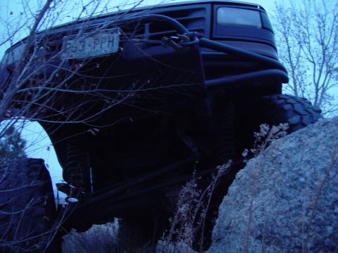 1993 Ford Bronco - Modified 1993 Ford Bronco navigating rocky terrain with a visible license plate.