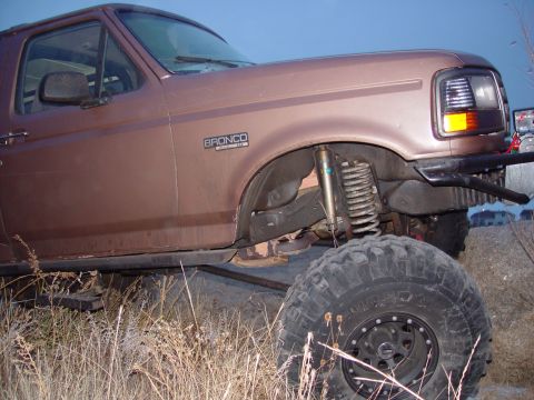 1993 Ford Bronco - This 1993 Ford Bronco features a lifted suspension and large off-road tires, suggesting it is modified for terrain.
