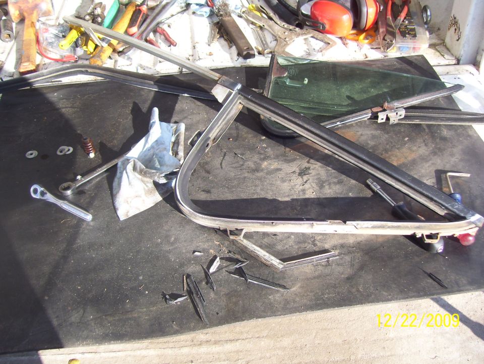 Disassembled window frame and parts on a workbench with tools