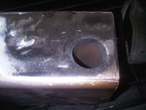 1996 Ford Bronco - This is a close-up view of a metal part, showing a circular opening and surface wear.